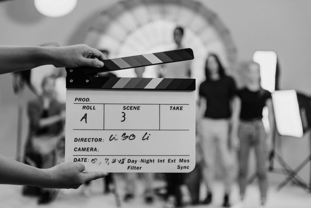 woman holding a movie production clapperboard 2022 09 16 09 16 18 8DX5WFF a